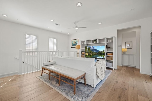 living room with ceiling fan and light wood-type flooring