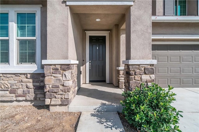 doorway to property with a garage