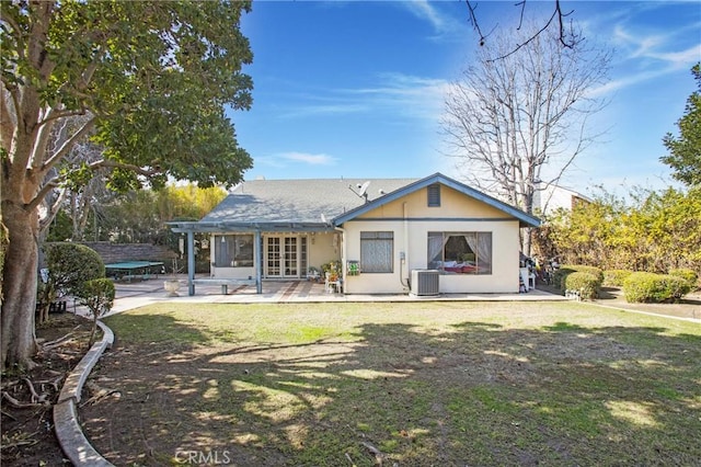 back of house with a patio area, french doors, central air condition unit, and a lawn