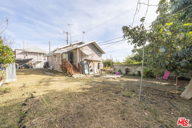 rear view of house with a lawn