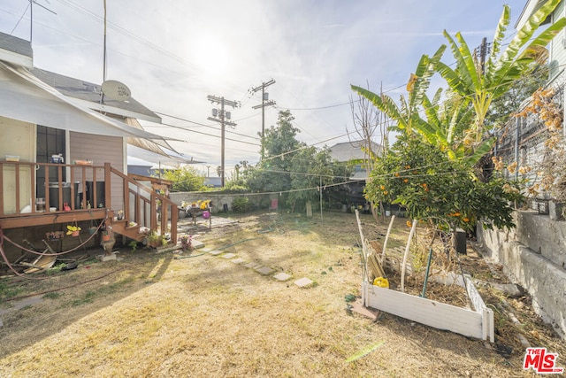 view of yard with a wooden deck