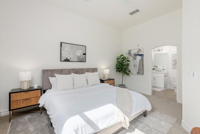 carpeted bedroom with ensuite bathroom