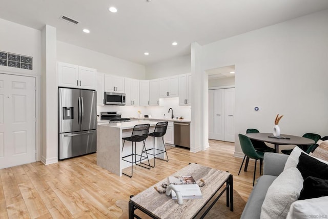 living room featuring light hardwood / wood-style floors and sink