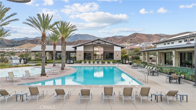 view of swimming pool with a mountain view and a patio