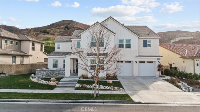 view of front property featuring a mountain view and a garage