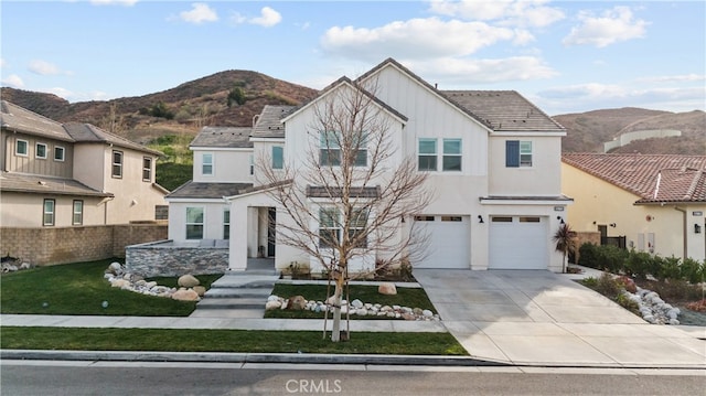 front facade with a garage and a mountain view