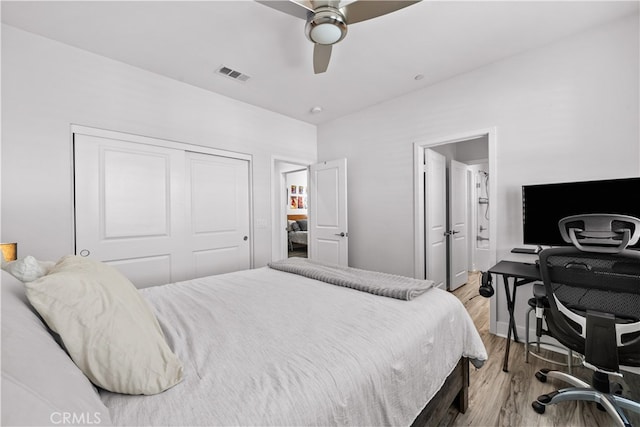 bedroom with ceiling fan, a closet, connected bathroom, and light hardwood / wood-style flooring