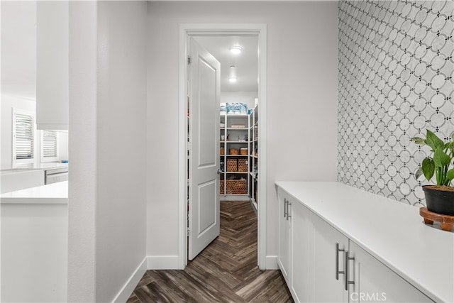 corridor featuring dark parquet flooring