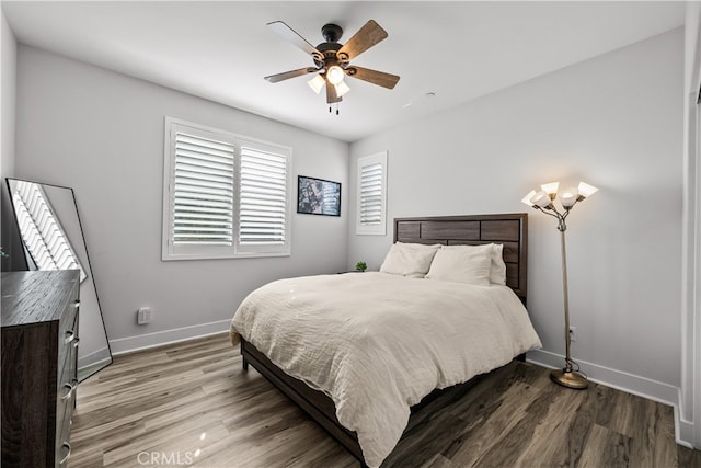 bedroom with hardwood / wood-style floors and ceiling fan