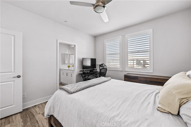 bedroom with ceiling fan, ensuite bath, and light hardwood / wood-style floors