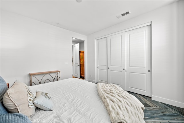 bedroom with hardwood / wood-style floors and a closet