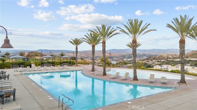 view of pool featuring a mountain view, a gazebo, and a patio