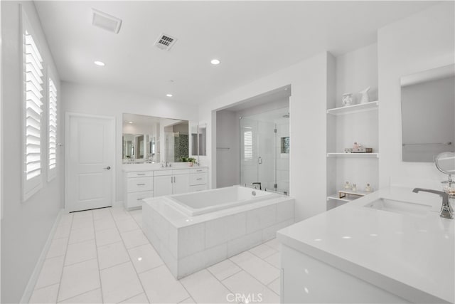 bathroom with tile patterned flooring, vanity, and shower with separate bathtub