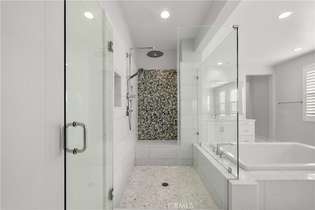 bathroom featuring shower with separate bathtub