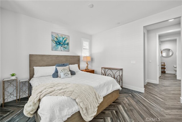 bedroom with dark parquet floors