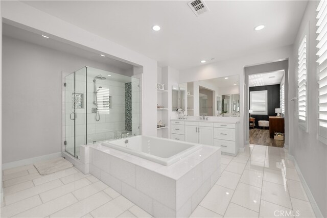 bathroom featuring vanity, shower with separate bathtub, and tile patterned flooring