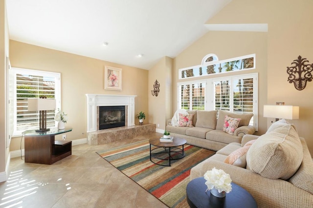 living room with a fireplace, high vaulted ceiling, and light tile patterned flooring