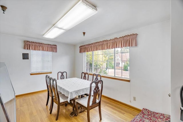 dining space with light hardwood / wood-style flooring