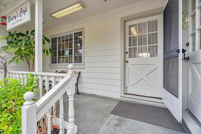 view of exterior entry with a porch