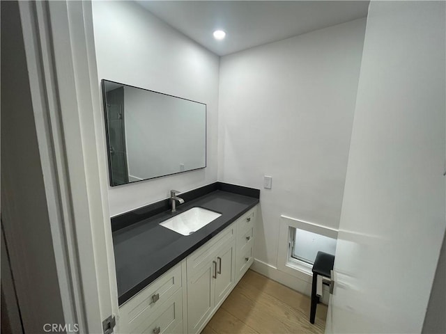 bathroom featuring vanity and hardwood / wood-style flooring