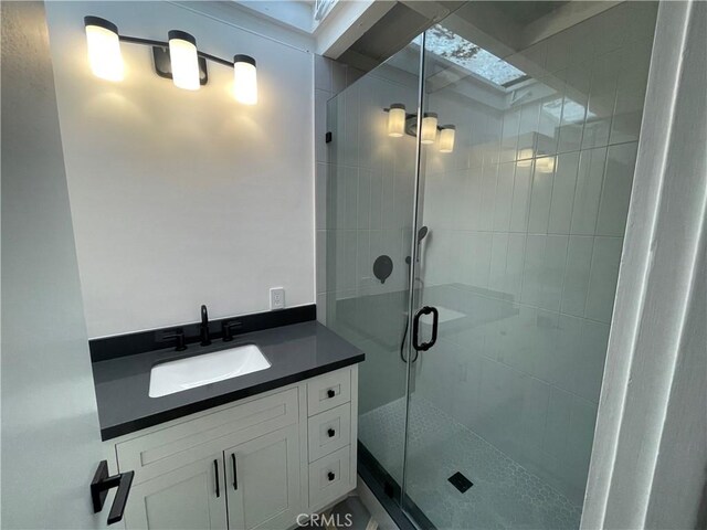 bathroom featuring an enclosed shower and vanity