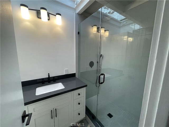 full bathroom with a stall shower and vanity