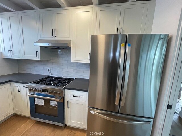 kitchen featuring white cabinetry, decorative backsplash, and stainless steel appliances