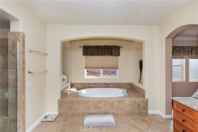 bathroom with tile patterned floors, vanity, and independent shower and bath