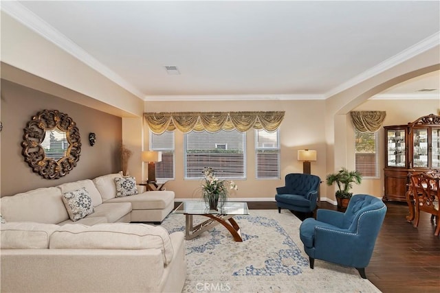 living room with crown molding, dark hardwood / wood-style floors, and a wealth of natural light