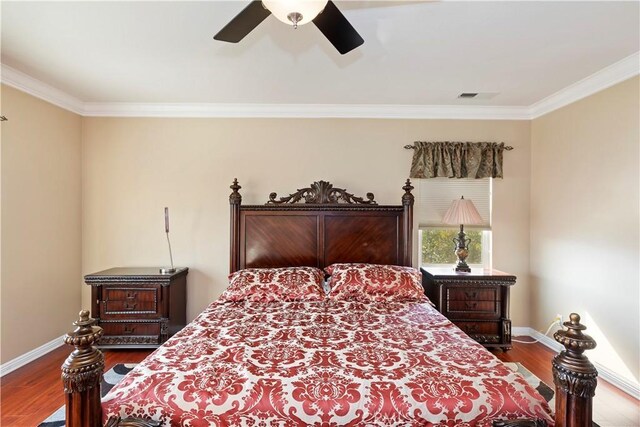 bedroom with wood-type flooring, ornamental molding, and ceiling fan