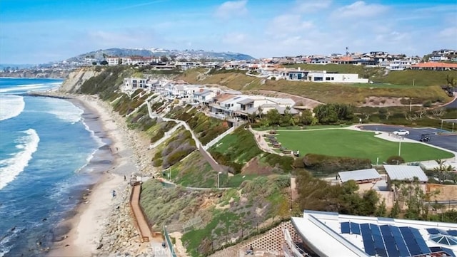 bird's eye view featuring a view of the beach and a water view