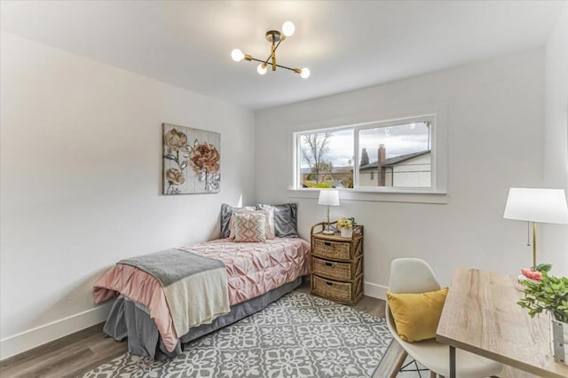 bedroom featuring a notable chandelier and wood-type flooring