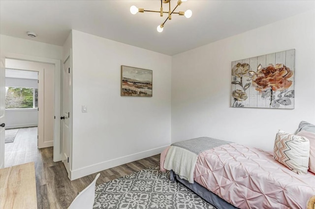 bedroom featuring hardwood / wood-style floors and a notable chandelier