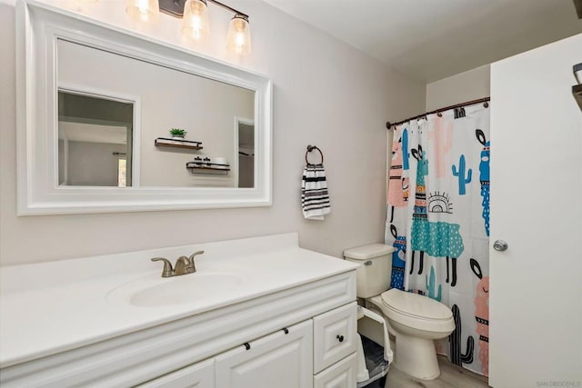 bathroom with vanity, toilet, and a shower with shower curtain