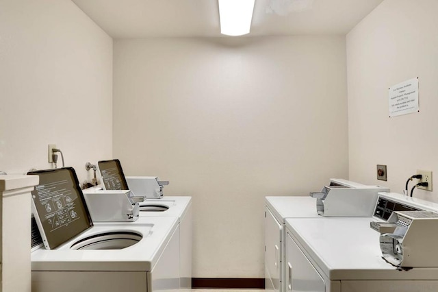 laundry area with washing machine and clothes dryer