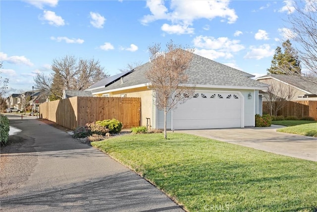 view of front facade with a garage and a front lawn