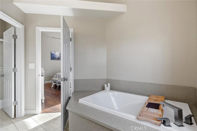 bathroom featuring tile patterned floors and a bath