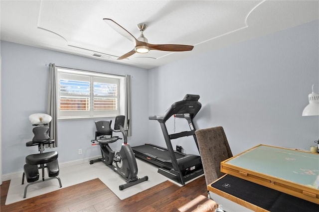 exercise room featuring ceiling fan and dark hardwood / wood-style flooring