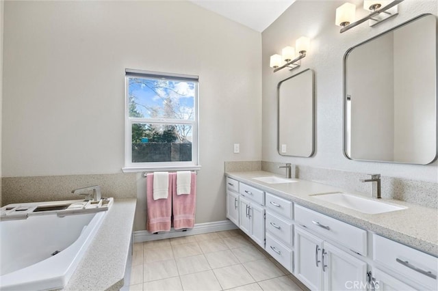 bathroom with a bath, tile patterned floors, and vanity