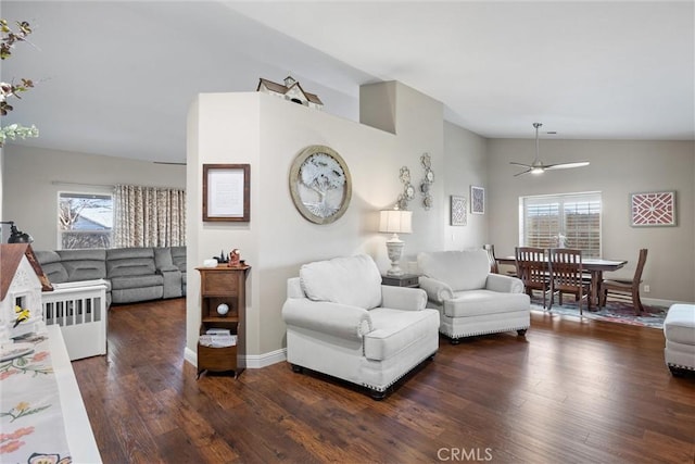 living room with dark hardwood / wood-style flooring, ceiling fan, and lofted ceiling