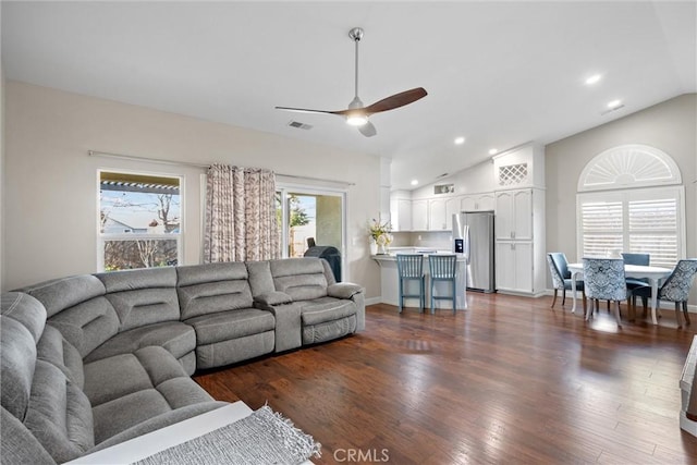 living room featuring dark hardwood / wood-style flooring, ceiling fan, and lofted ceiling