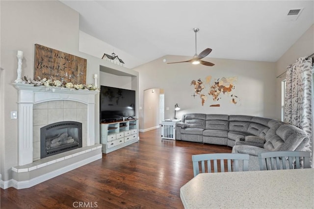 living room with a fireplace, ceiling fan, vaulted ceiling, and dark hardwood / wood-style flooring