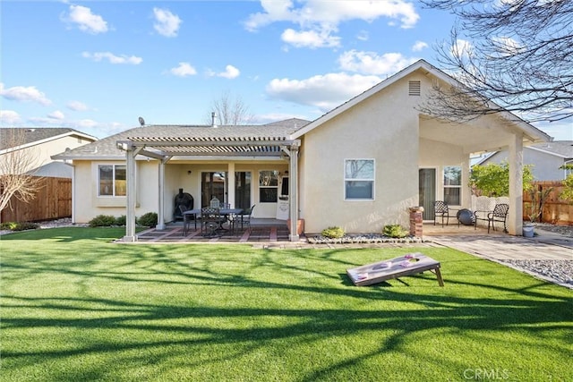 back of property featuring a patio, a yard, and a pergola