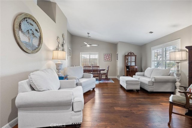 living room with dark wood-type flooring, high vaulted ceiling, and plenty of natural light