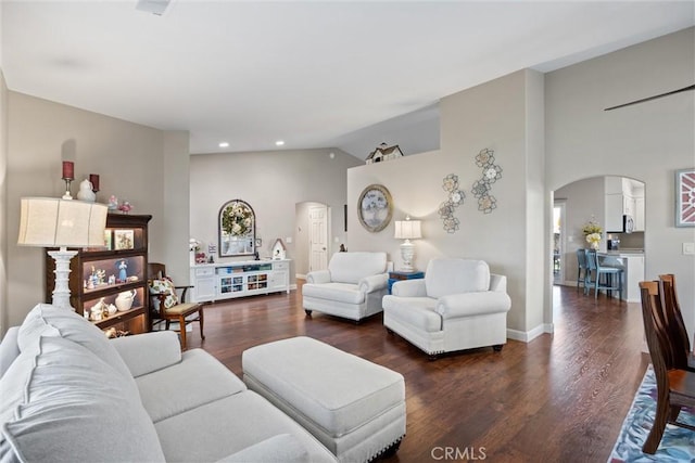 living room featuring lofted ceiling and dark hardwood / wood-style flooring