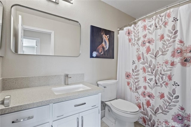 bathroom featuring vanity, a shower with curtain, and toilet