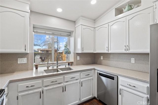 kitchen featuring sink, stainless steel appliances, white cabinetry, and tasteful backsplash