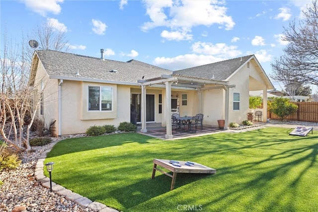 back of property featuring a lawn and a patio area