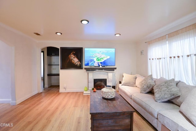 living room featuring ornamental molding and light hardwood / wood-style floors