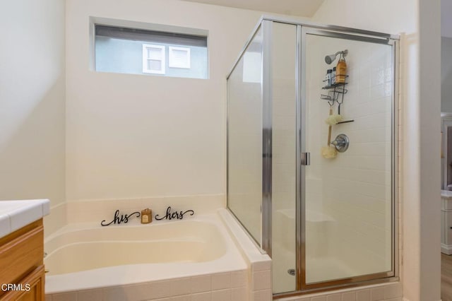 bathroom with vanity and independent shower and bath